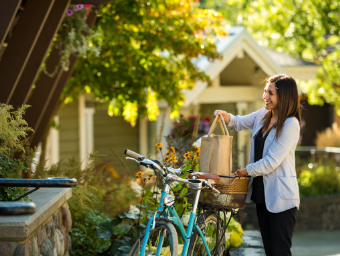 a woman standing next to a blue bicycle.