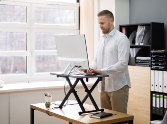 a man standing in front of a laptop computer.