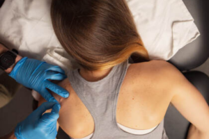2 - RecoverRx - RecoverRx a woman in a gray tank top and blue gloves.