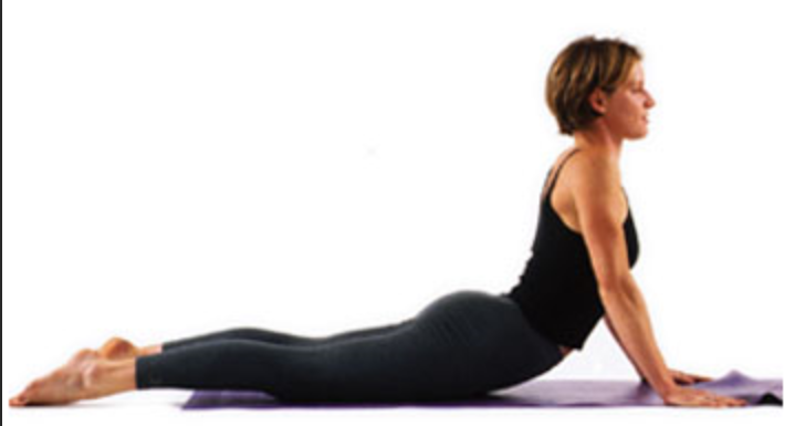 a woman is doing a yoga pose on a mat.