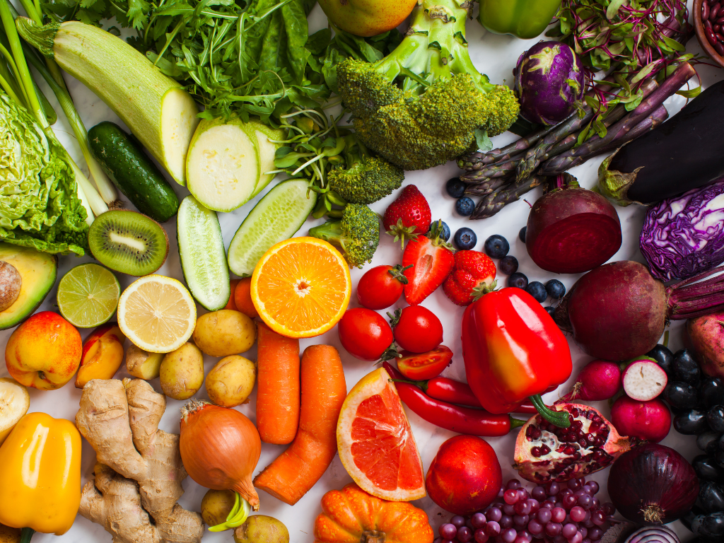 a bunch of different fruits and vegetables on a table.