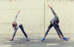 a couple of people that are doing a yoga pose.