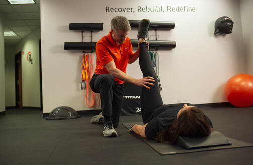 a man and a woman doing exercises in a gym.