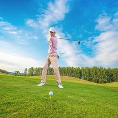 a man hitting a golf ball with a golf club.