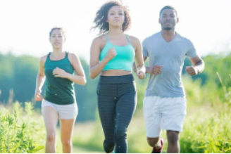 a group of people running in a field.