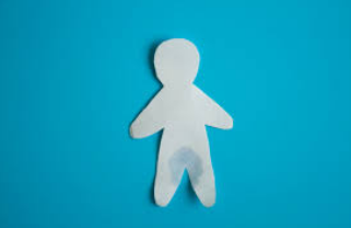 a paper cutout of a person on a blue background.