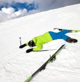 a person laying on the ground in the snow.