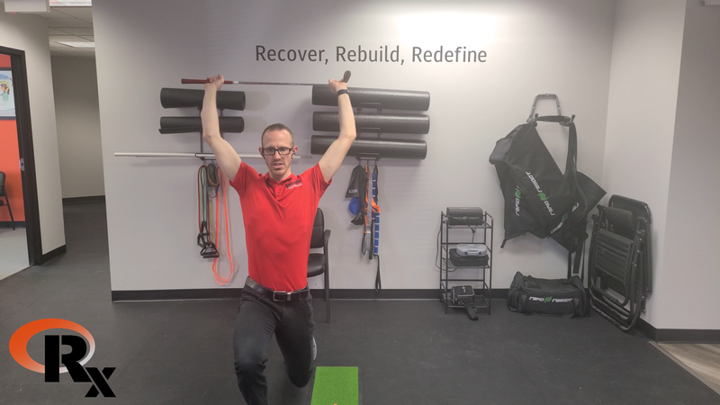 a man in a red shirt is doing exercises in a gym.