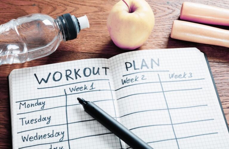 A notebook with a workout plan on it.