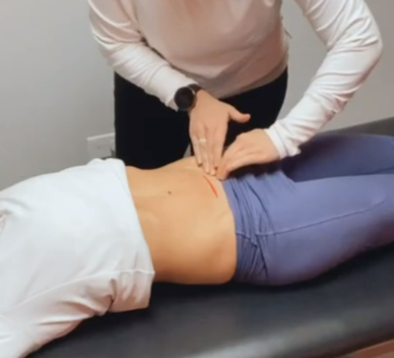 A woman is being examined by a physical therapist.